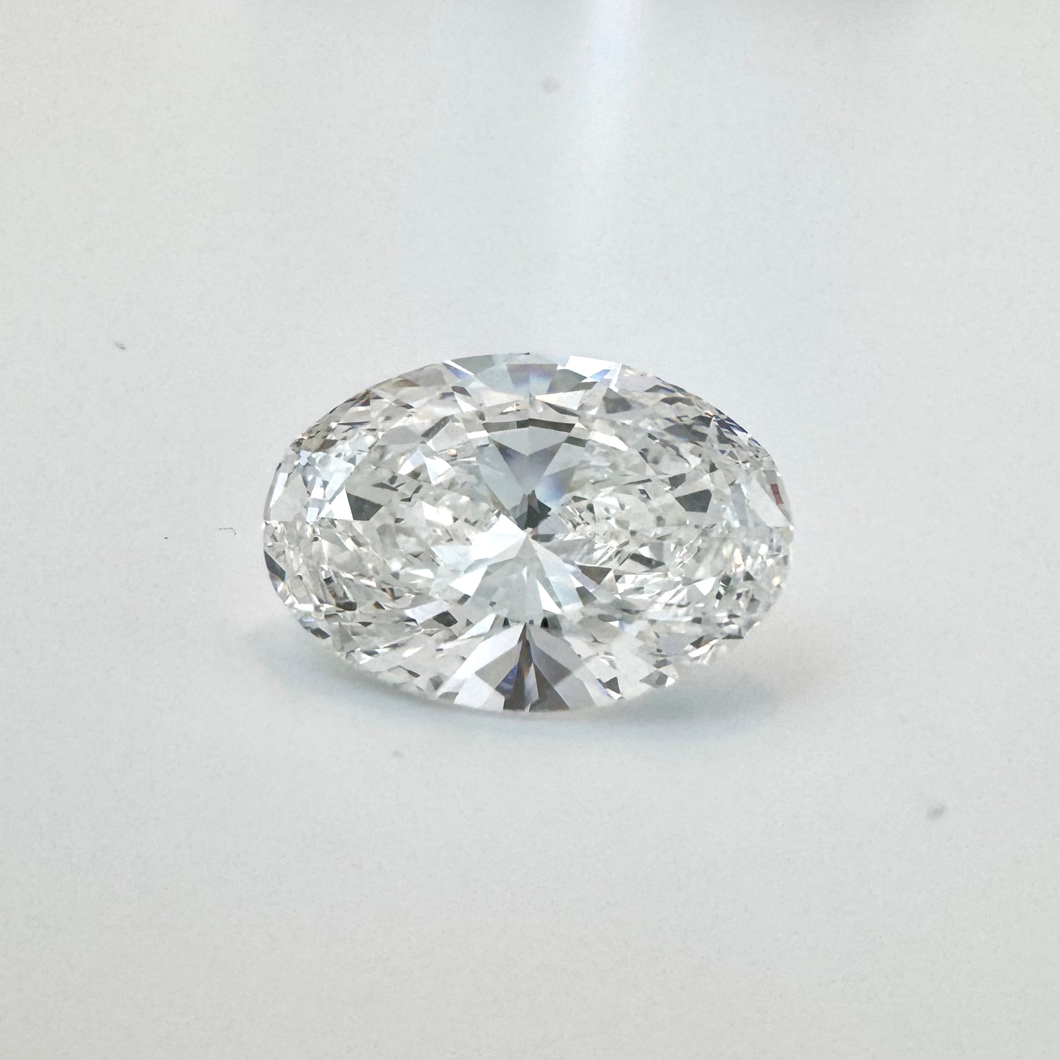 7.03 Carat Oval Brilliant Lab-Grown Diamond on White Surface