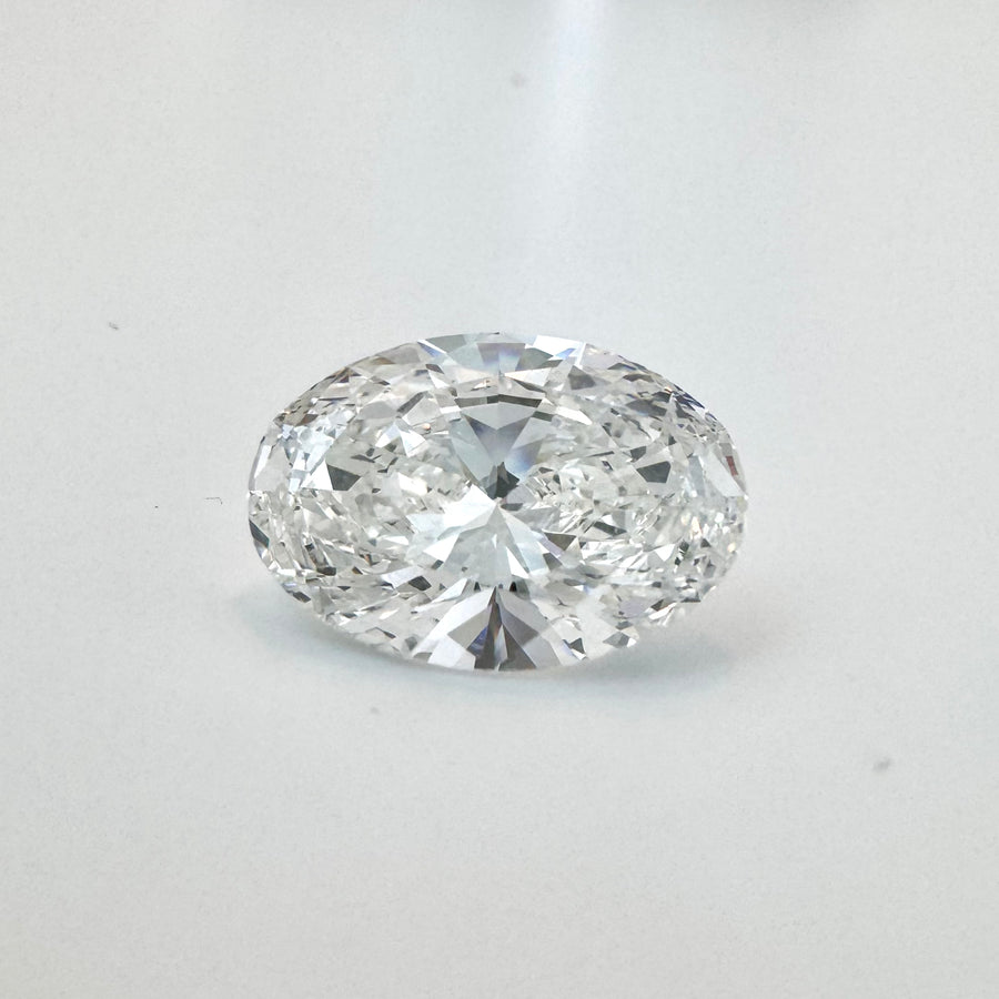 7.03 Carat Oval Brilliant Lab-Grown Diamond on White Surface