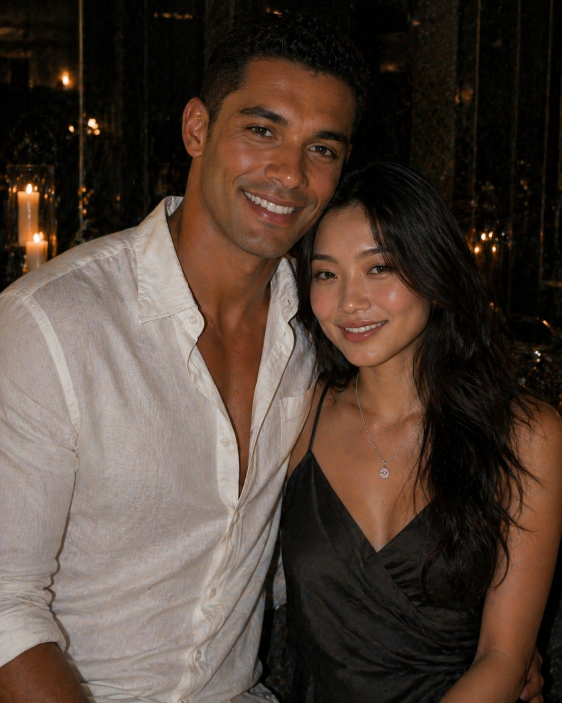 Man and woman posing together in a dimly lit setting